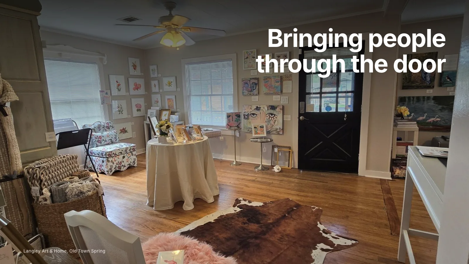 Furniture showroom with styled room settings and customers browsing