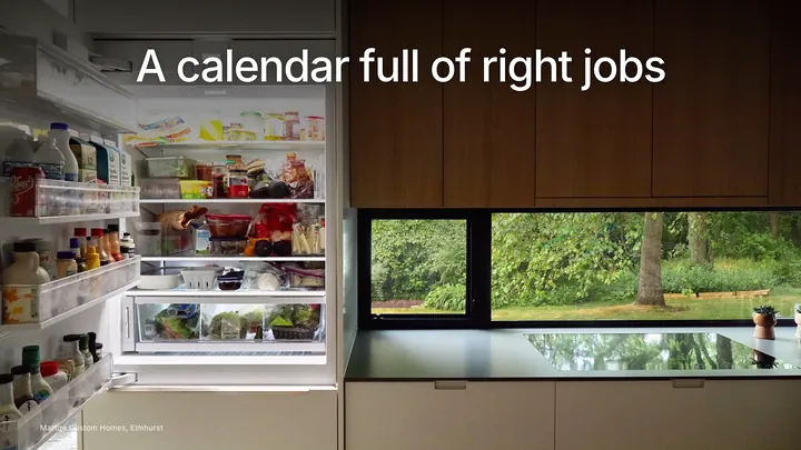 Remodeling company owner reviewing a full project calendar beside finished work photos